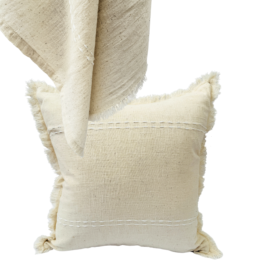Beige textured cushion with frayed edges.