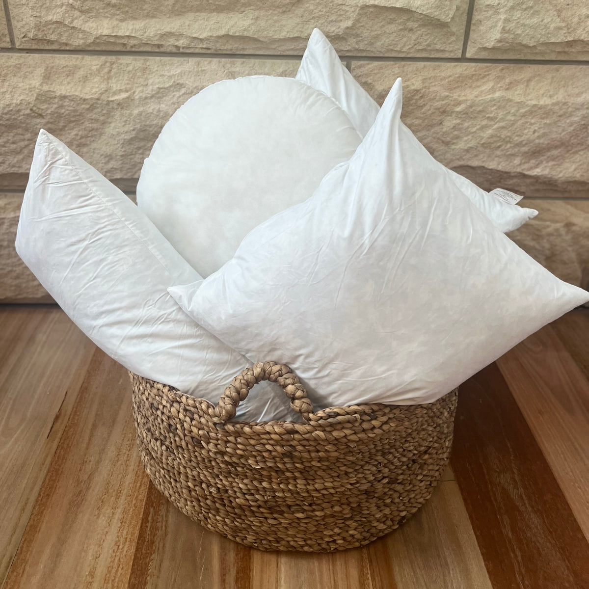 Basket with white cushions.
