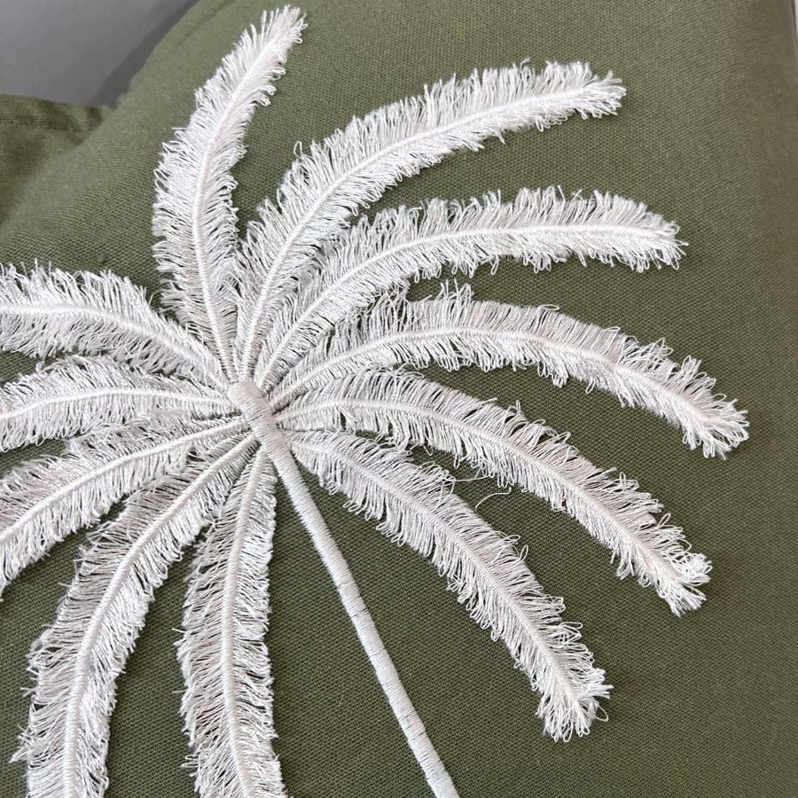 Palm tree on a decorative green fabric.