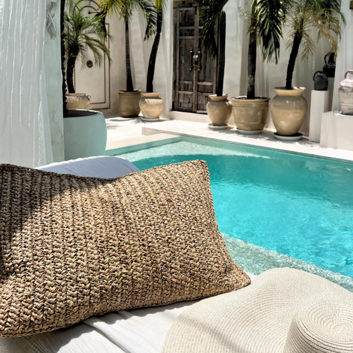 raffia cushion by a pool