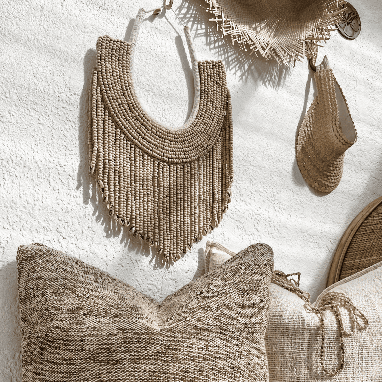 Beaded wall art with a woven cushion and hats