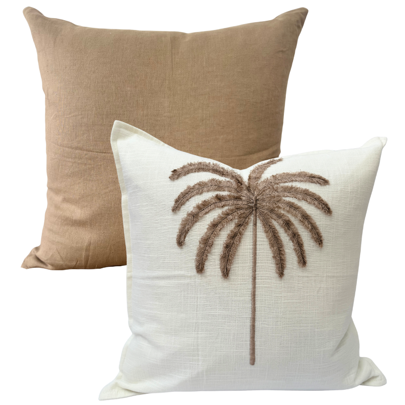Beige cushion and white cushion with palm tree design.