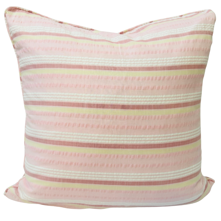 Striped cushion with pink and white pattern.