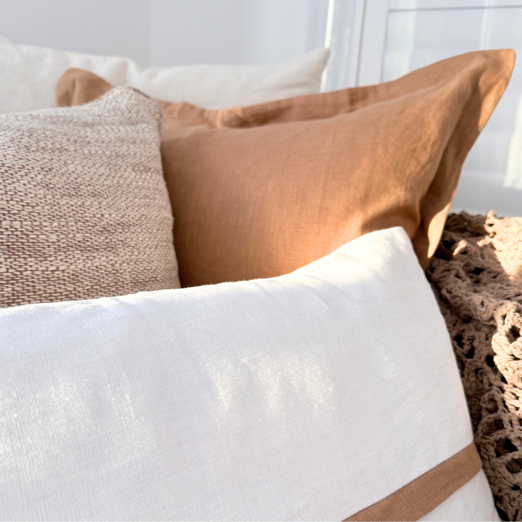 Close-up of textured cushion on a sofa with a neutral color palette.