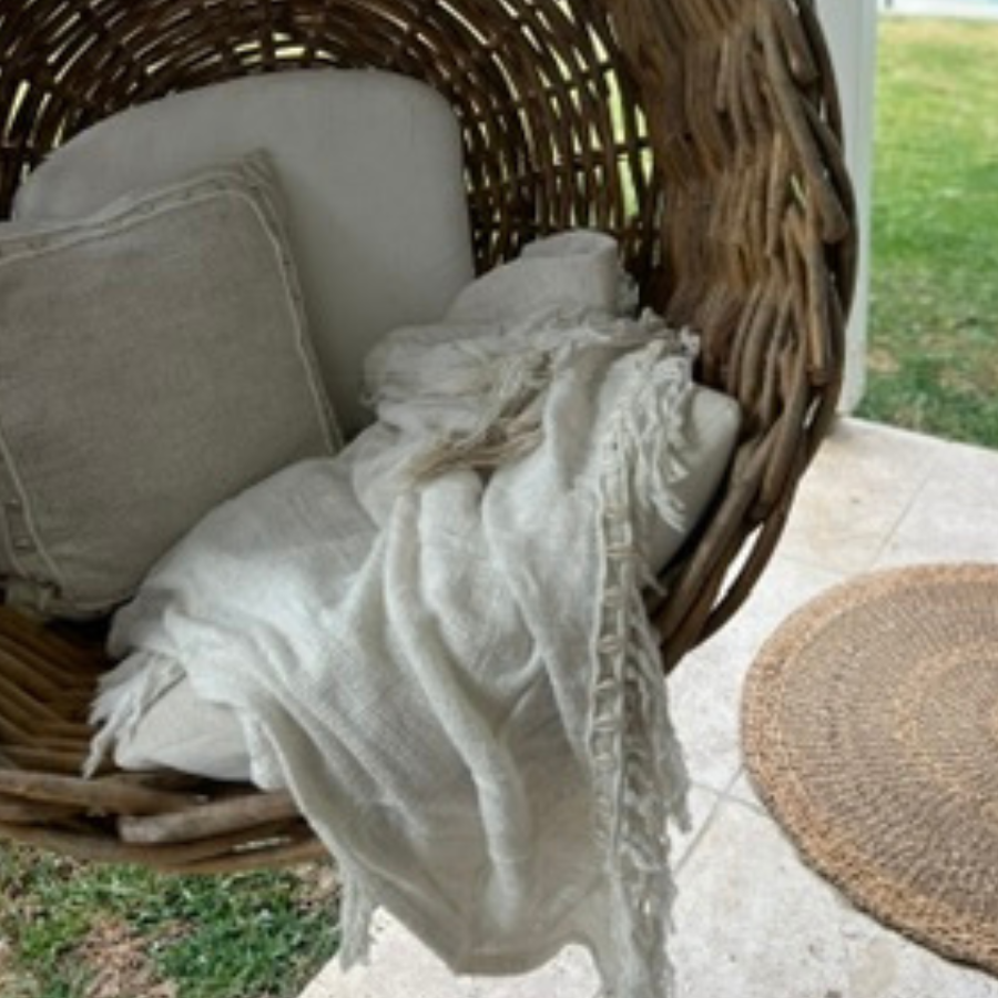Shell square cushion natural throw in garden