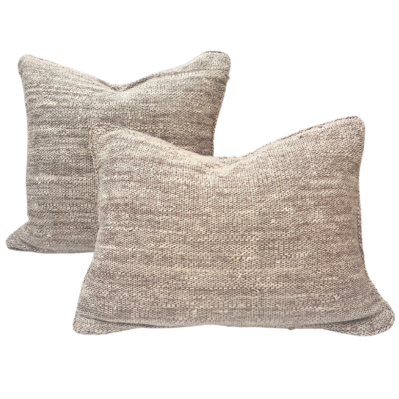 Two rectangular handwoven oatmeal cushions with a textured jute and cotton blend fabric.