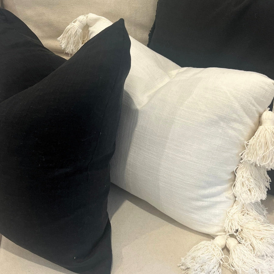 Black and white cushions on a sofa.
