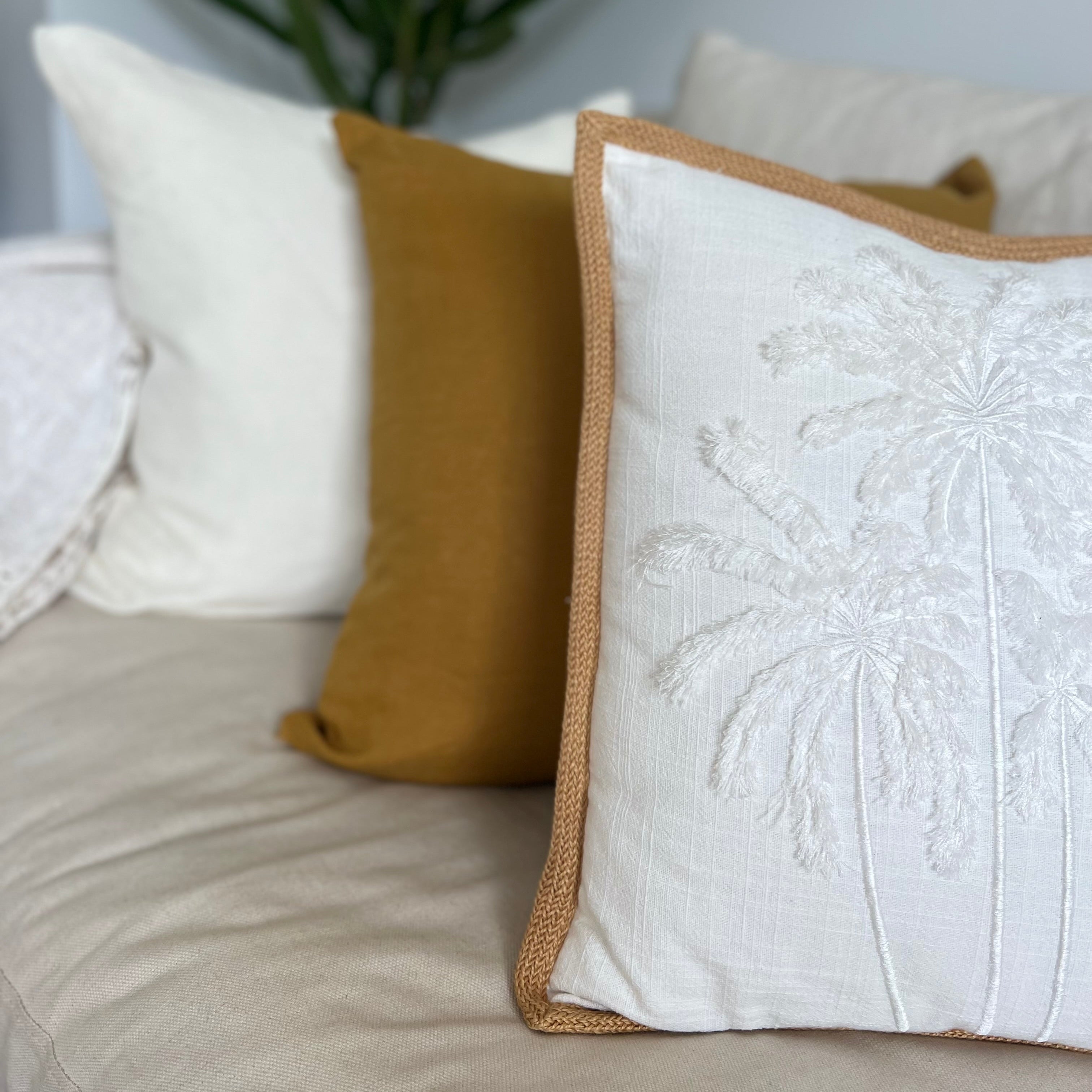 Cushions with palm tree decor.