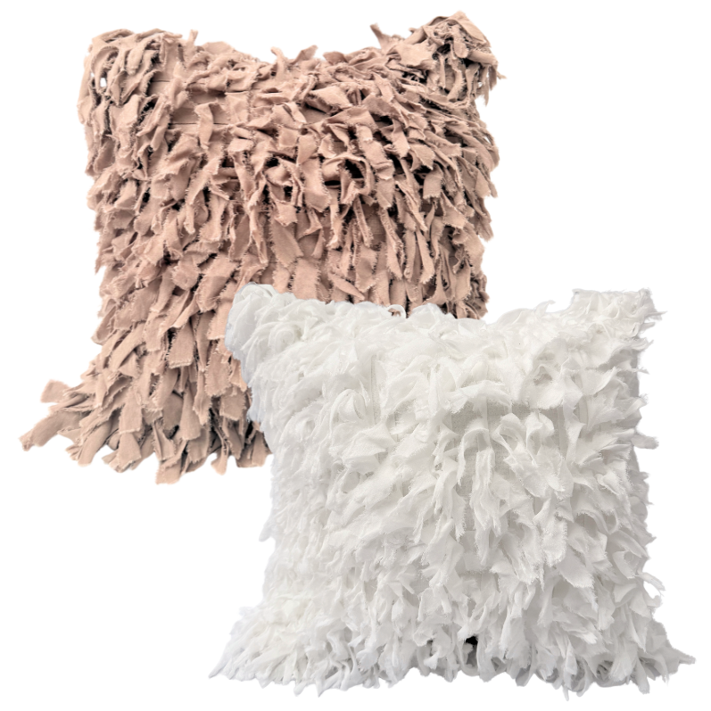Two fluffy cushion, one pink and one white.