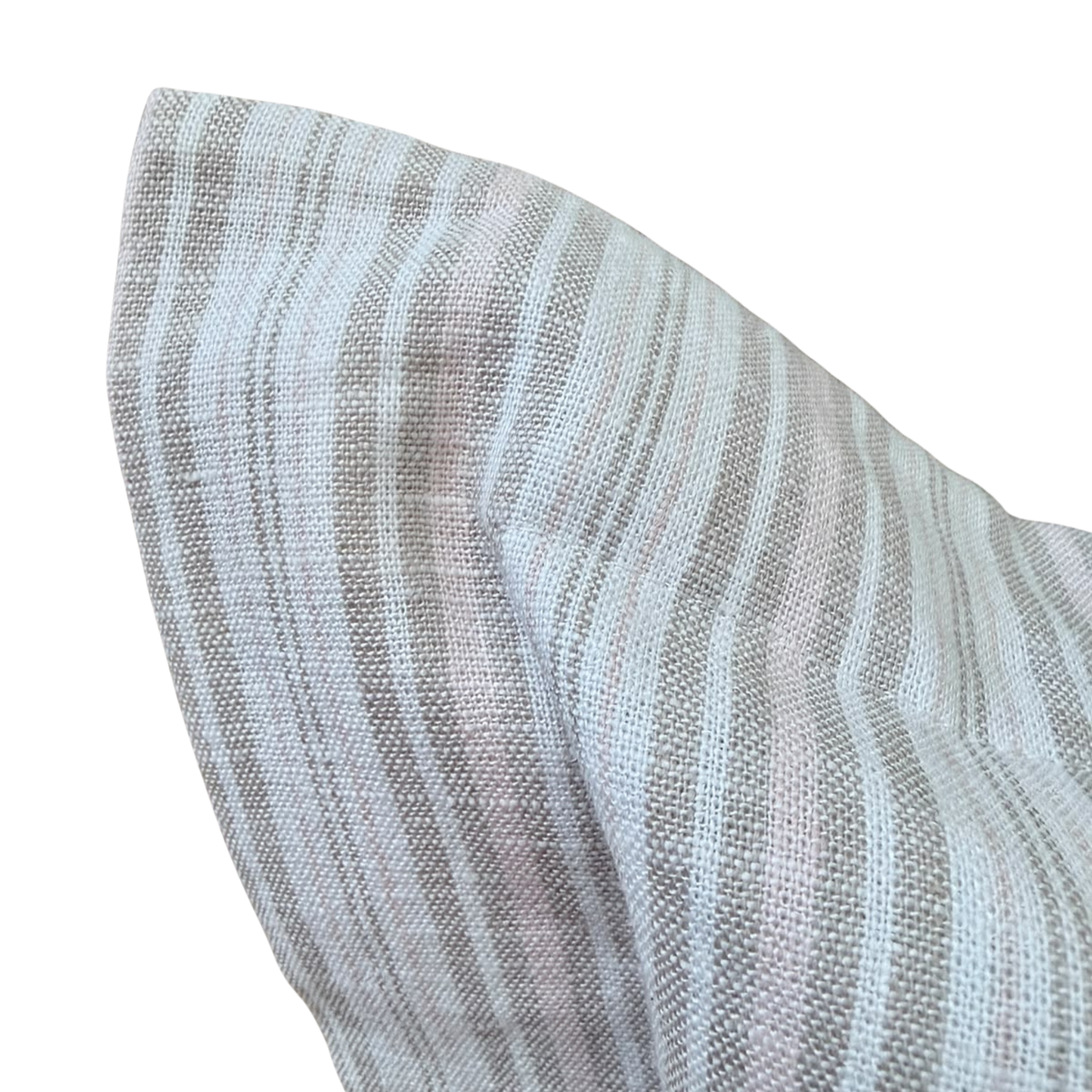 Detail view of the soft structured corner on a neutral woven linen cushion.