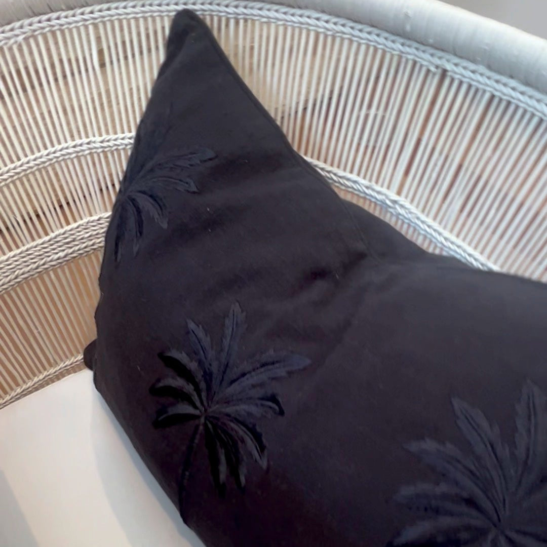 Black rectangle cushion on a chair.