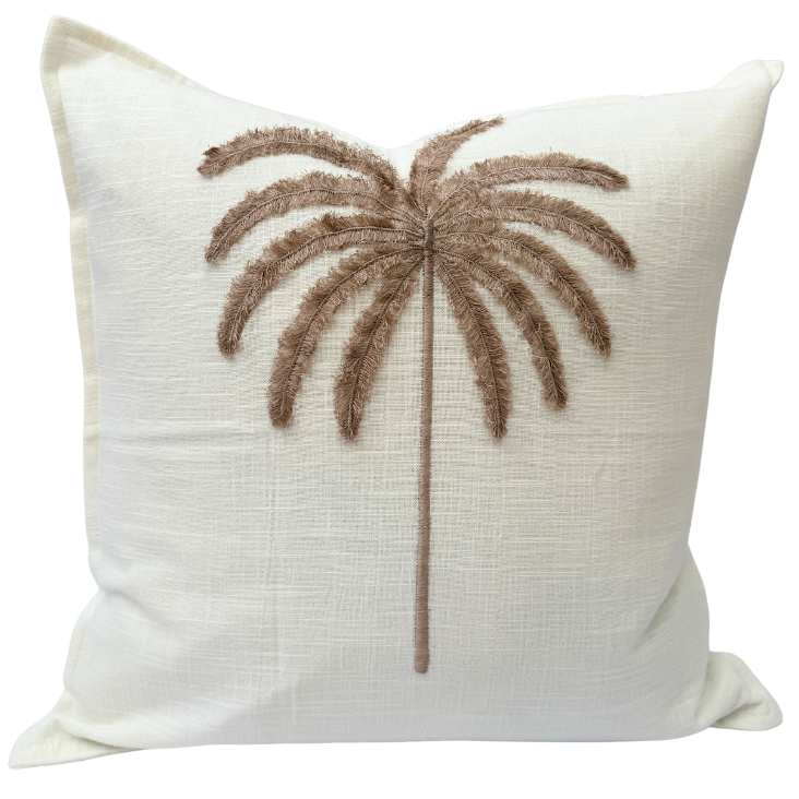 Decorative cushion with a palm tree design.