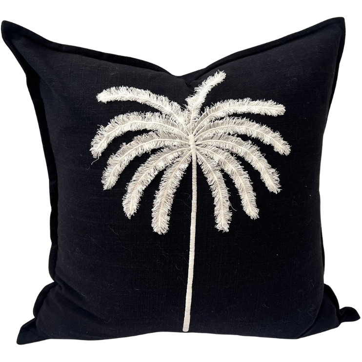 Black cushion with palm tree decor.