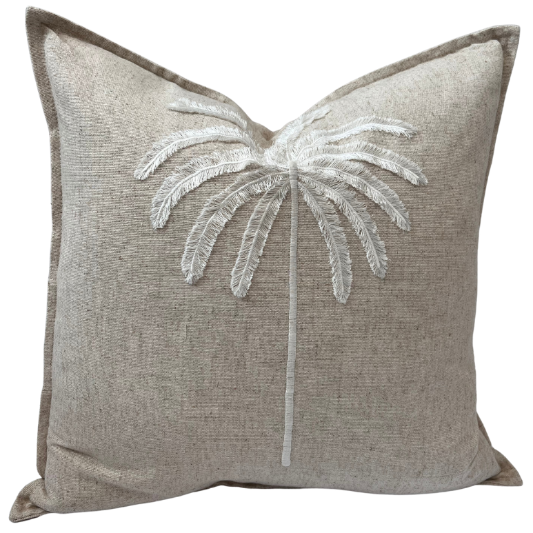 A square-shaped cushion cover with a tufted embroidered palm design in a natural color palette.