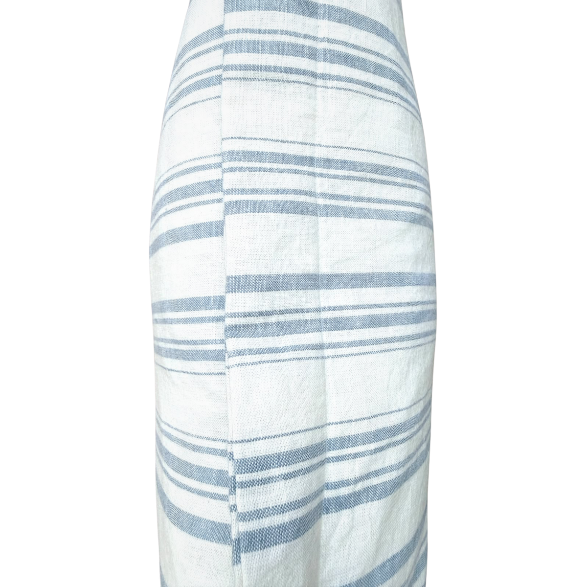 Side profile view showing the piped edge seam and woven texture of a blue striped linen cushion.