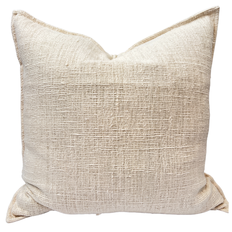 A beige cotton cushion with a textured front and solid back, neatly folded and presented.