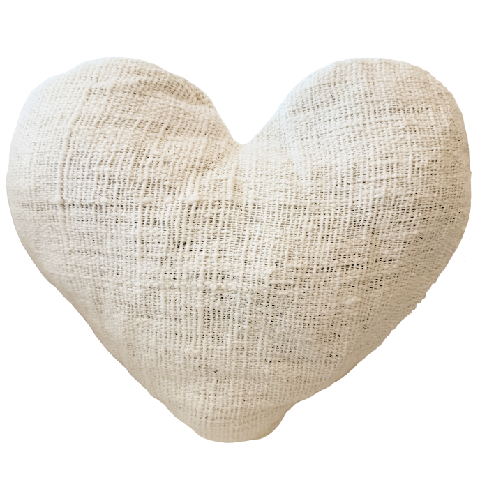 Heart-shaped cushion made of textured fabric.