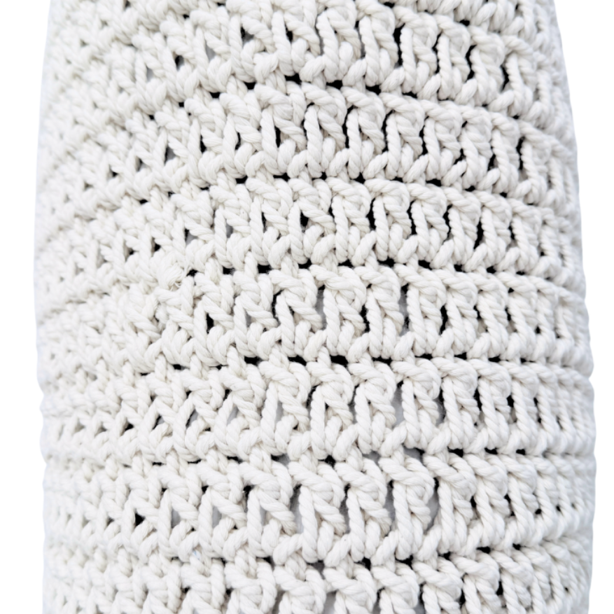 White crocheted cushion on a white background