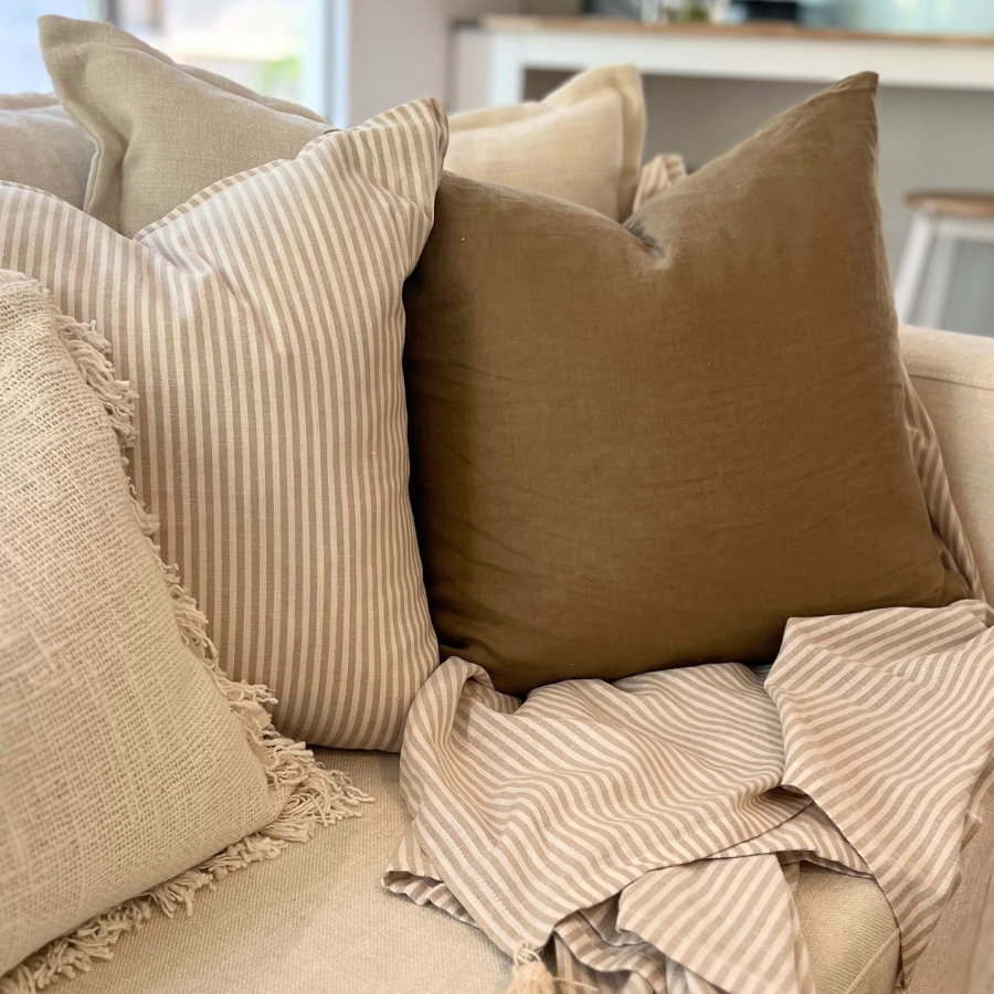 Cushions on sofa with flower decor.