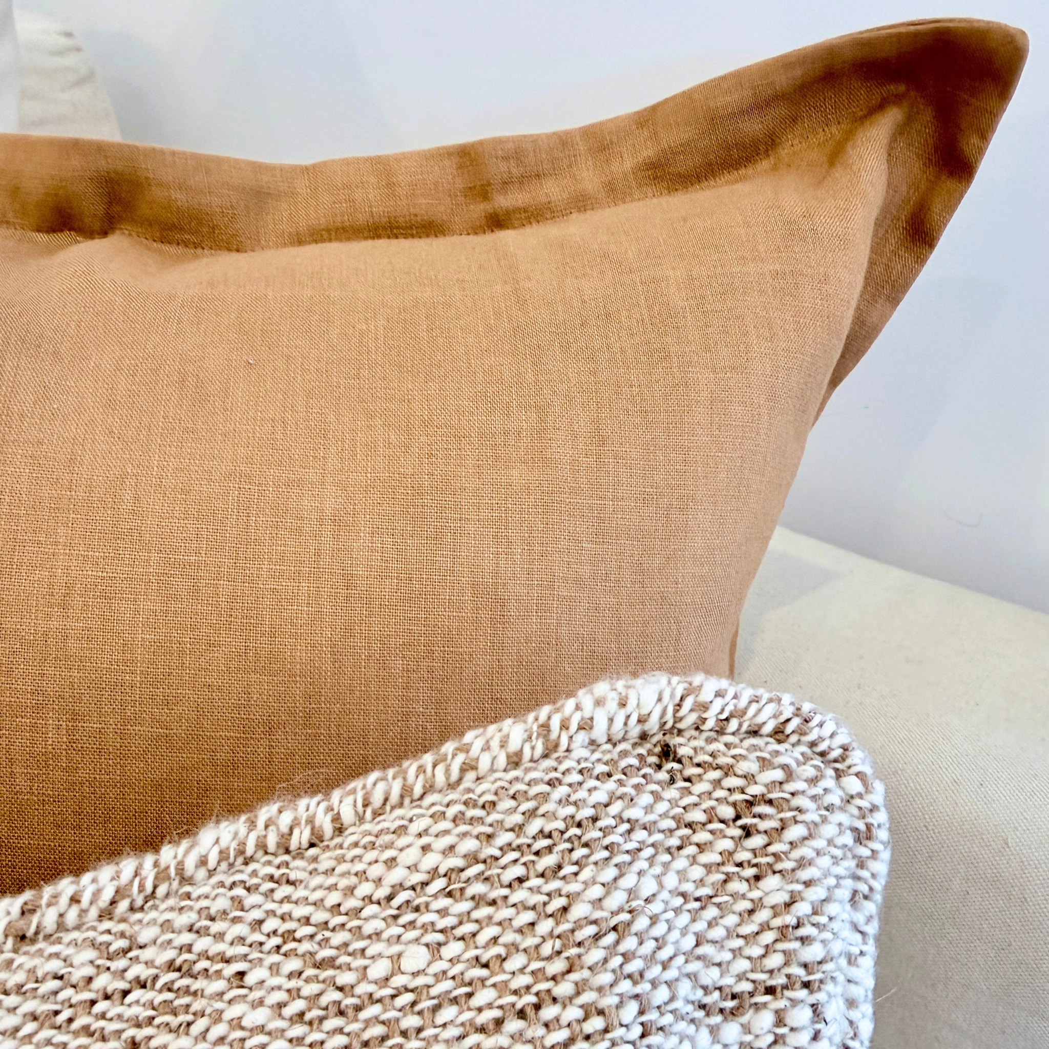 Brown textured cushion on a beige sofa.