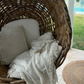 Shell square cushion natural throw in garden